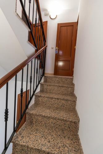 a set of stairs with a wooden door at San Antón in Cazorla