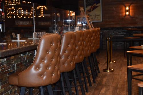 a row of brown leather seats in a bar at Taos Valley Lodge in Taos