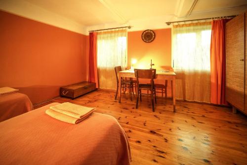 a room with a bed and a table and chairs at Coastal Home Muini Ūši in Kolka