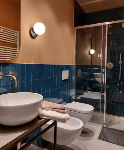 a bathroom with a sink and a toilet and a shower at the 6 apartments in Rimini