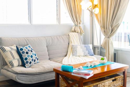 a living room with a couch and a coffee table at Beautiful Studio in the Heart of Vibrant Waikiki in Honolulu