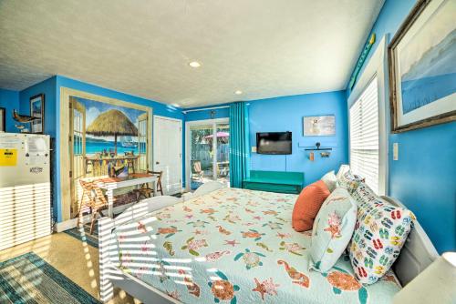 a blue bedroom with a bed and a view of the ocean at Studio Steps to Beach and about 7 Miles to Pier Park! in Panama City Beach