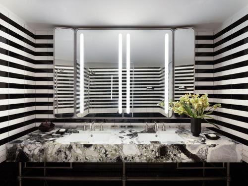 a bathroom with a sink and a large mirror at Park Lane New York in New York