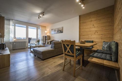 a living room with a couch and a table and chairs at Ferienwohnung Staufenpanorama mit herrlicher Aussicht in Bad Reichenhall