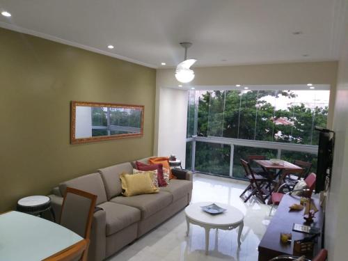 a living room with a couch and a table at Summer Dream in Cabo Frio