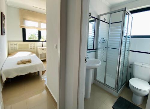 a bathroom with a toilet and a sink and a shower at Regia Bahia en Cabo Roig in Orihuela Costa