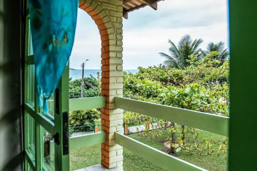 an open window with a view of the ocean at O Costão do Sol in Balneário Camboriú