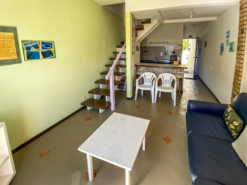a living room with a blue couch and a table at O Costão do Sol in Balneário Camboriú