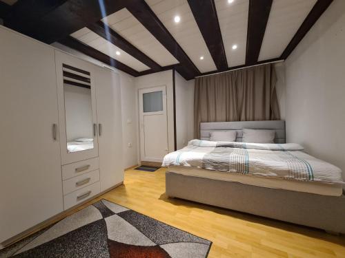 a bedroom with a bed and a coffered ceiling at Koper step to the sea in Koper