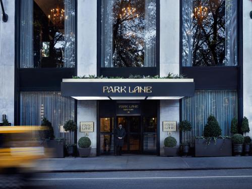 a man standing outside of a park lane building at Park Lane New York in New York