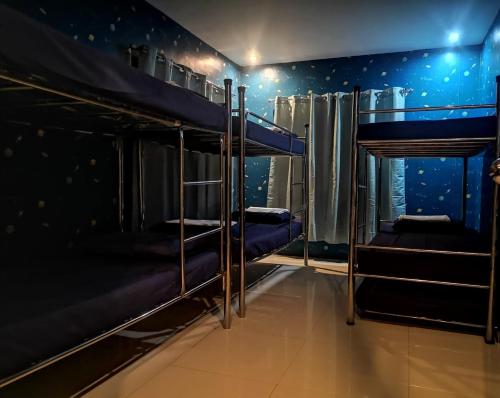 a room with bunk beds with a wall of stars at McHanns Place in Antipolo