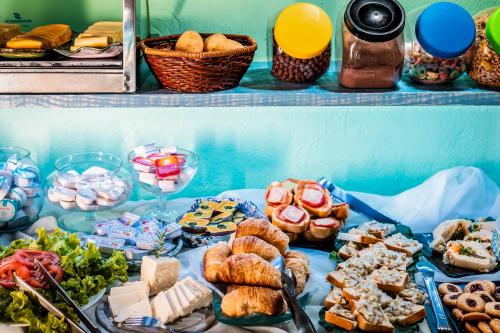 a table with different types of food on it at O Costão do Sol in Balneário Camboriú