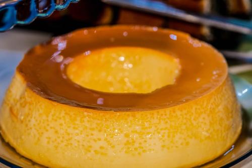 a piece of food on a plate with caramel sauce at O Costão do Sol in Balneário Camboriú