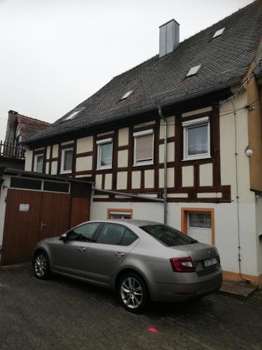 a car parked in front of a house at Gästehaus Ochsenhof in Feuchtwangen