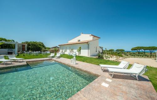 a villa with a swimming pool and a house at Bellimpiazza - Villa vista mare con piscina in Sorso