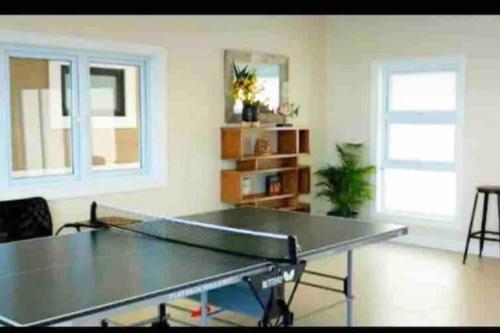 a ping pong table in a living room at Natty’s Cozy Beach house in Hanover Jamaica in Point