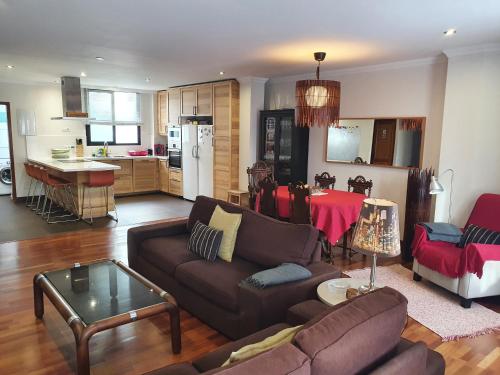 a living room with a couch and a table at Alcaravaneras Home in Las Palmas de Gran Canaria