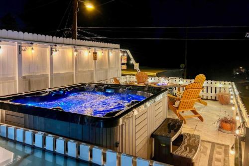 a large hot tub on a patio at night at Cabin with Mountain Views about 2 Mi to Ruidoso Midtown! in Ruidoso