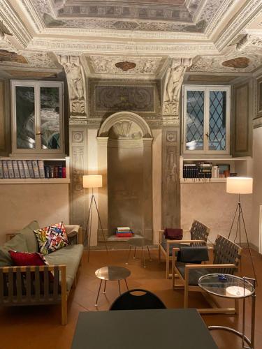 a living room with couches and tables and a ceiling at Intero Appartamento. San Giovanni Uno in Brescia