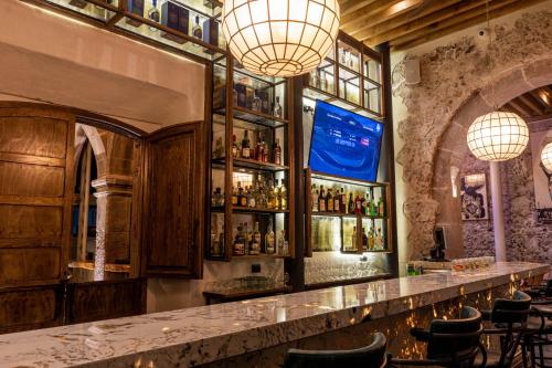 a bar with a marble counter and lights at Casa 1810 Parque Hotel Boutique in San Miguel de Allende