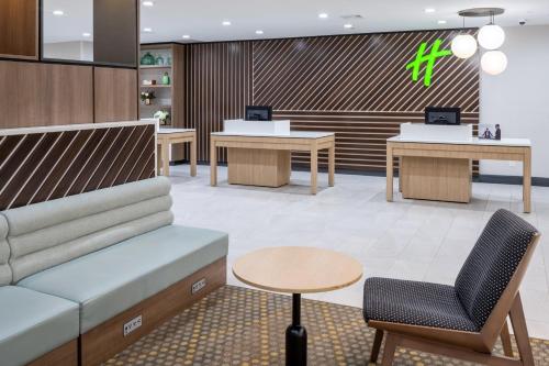 a waiting room with a couch and a table at Holiday Inn - Long Island - ISLIP Arpt East by IHG in Holtsville
