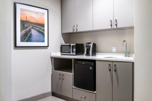 a kitchen with a sink and a microwave at Holiday Inn - Long Island - ISLIP Arpt East by IHG in Holtsville