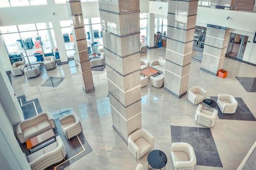 an overhead view of a lobby with couches and chairs at Arena Hotel Kur in Mingachevir