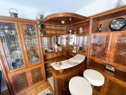 a room with wooden cabinets and white stools at Holiday home in Jadranovo 42254 in Jadranovo