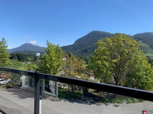 a view from a balcony of a mountain range at Black Rooster Guesthouse in Prince Rupert