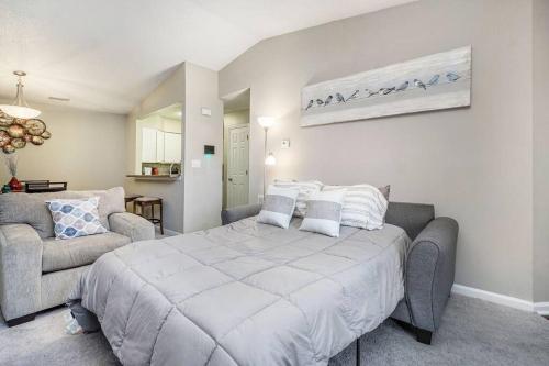 a bedroom with a large bed and a couch at Charming Apartment with Wi-Fi in Charlotte