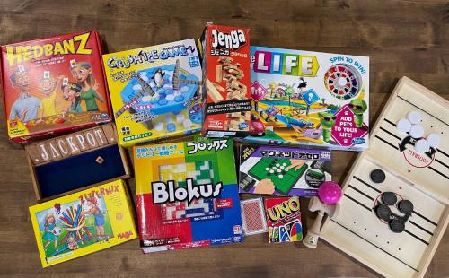 a pile of games and toys on a table at Guesthouse All you need - All rooms have an ocean view! in Shimoda