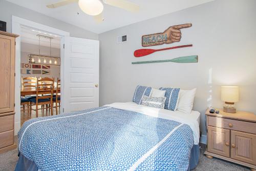 a bedroom with a bed with a blue and white comforter at Merchant Street Retreat in New Buffalo