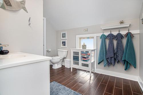 a bathroom with a toilet and a sink at Merchant Street Retreat in New Buffalo