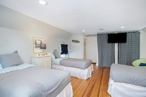 a bedroom with two beds and a tv in it at Merchant Street Retreat in New Buffalo