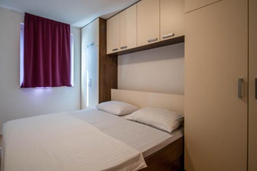 Un pat sau paturi într-o cameră la Apartments Jadra