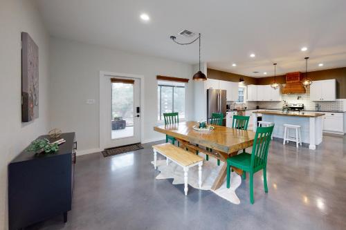 a kitchen and dining room with a wooden table and chairs at Dry Creekside Casita in Fischer
