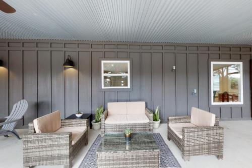 a patio with two wicker chairs and a table at Dry Creekside Casita in Fischer