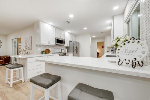 a white kitchen with a large white counter top at Sun City's Charmer in Sun City