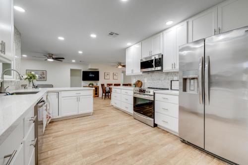 a kitchen with white cabinets and stainless steel appliances at Sun City's Charmer in Sun City