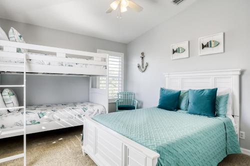 a bedroom with two bunk beds and blue pillows at Gulf Getaway in Clearwater Beach