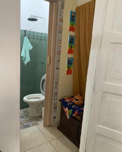 a bathroom with a toilet and a shower at Pousadinha da Lulu - Pontal Mangue Seco in Indiaroba