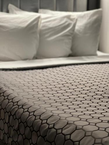 a close up of a bed with white pillows at Chateau Suites in Norristown