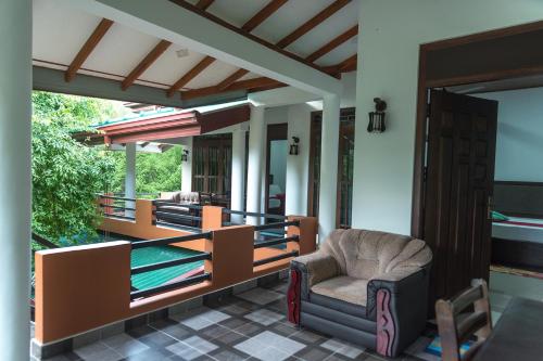 a house with a porch with a chair at Sadee's Place in Dambulla