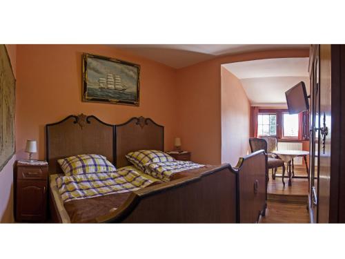 a bedroom with a bed and a living room at Villa Bergera in Dzierżoniów