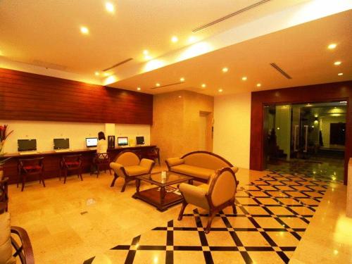a lobby with chairs and a table in a building at Sabaidee@Lao Hotel Vientiane in Vientiane