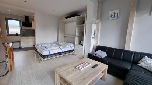a living room with a couch and a bed at FeWo an der Ostsee Nr. 2 in Rerik