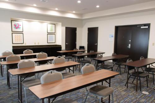 a classroom with desks and chairs and a chalkboard at Holiday Inn Express Hotel & Suites Temple-Medical Center Area by IHG in Temple