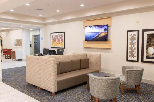 a waiting room with a couch and chairs at Holiday Inn Express Hotel & Suites Temple-Medical Center Area by IHG in Temple
