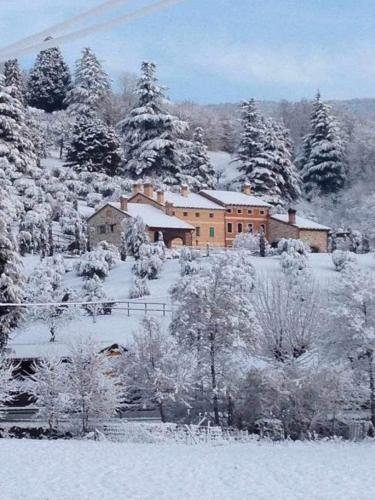 a house is covered in snow on a hill at Borghetto San Biagio Relais Agriturismo in Thiene
