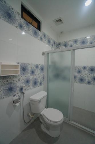 a bathroom with a toilet and a shower at Skylodge Resort in Coron